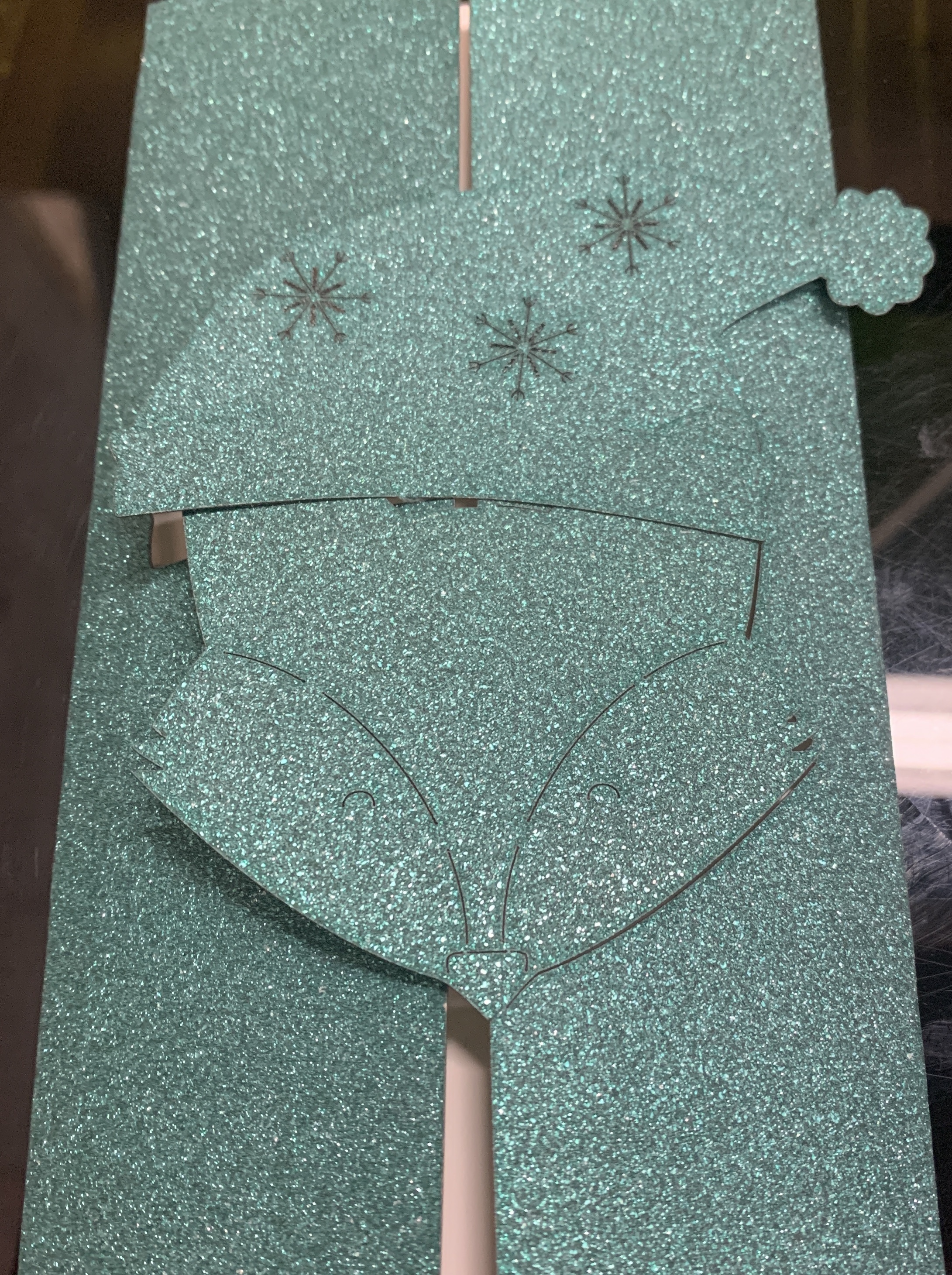 Trifold glitter cardstock Christmas card with laser cut cartoon fox wearing holiday cap